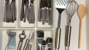 A drawer with various kitchen utensils organized in compartments. - House with free public parking (Köln)