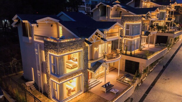 A modern residential building with multiple levels, balconies, and outdoor seating areas. - ELIVAAS privé Royce Rose 4BHK Hilltop (Kasauli)
