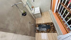 A bathroom with a shower, sink, and potted plant. - Freedom River House (Ahangama)