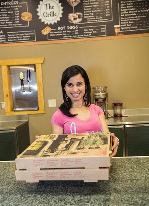 A person holding a menu at a restaurant.