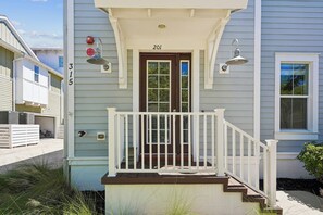 A residential building with a front porch, a door labeled '201', and a number '315' on the wall. - Mangrove Walk-30+ Day Rental in Harbour Isle in Perico (Bradenton)