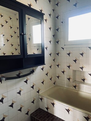 A bathroom with a mirror, a window, and patterned tiles. - House with breathtaking views of Toulouse 3 bedrooms (Launaguet)