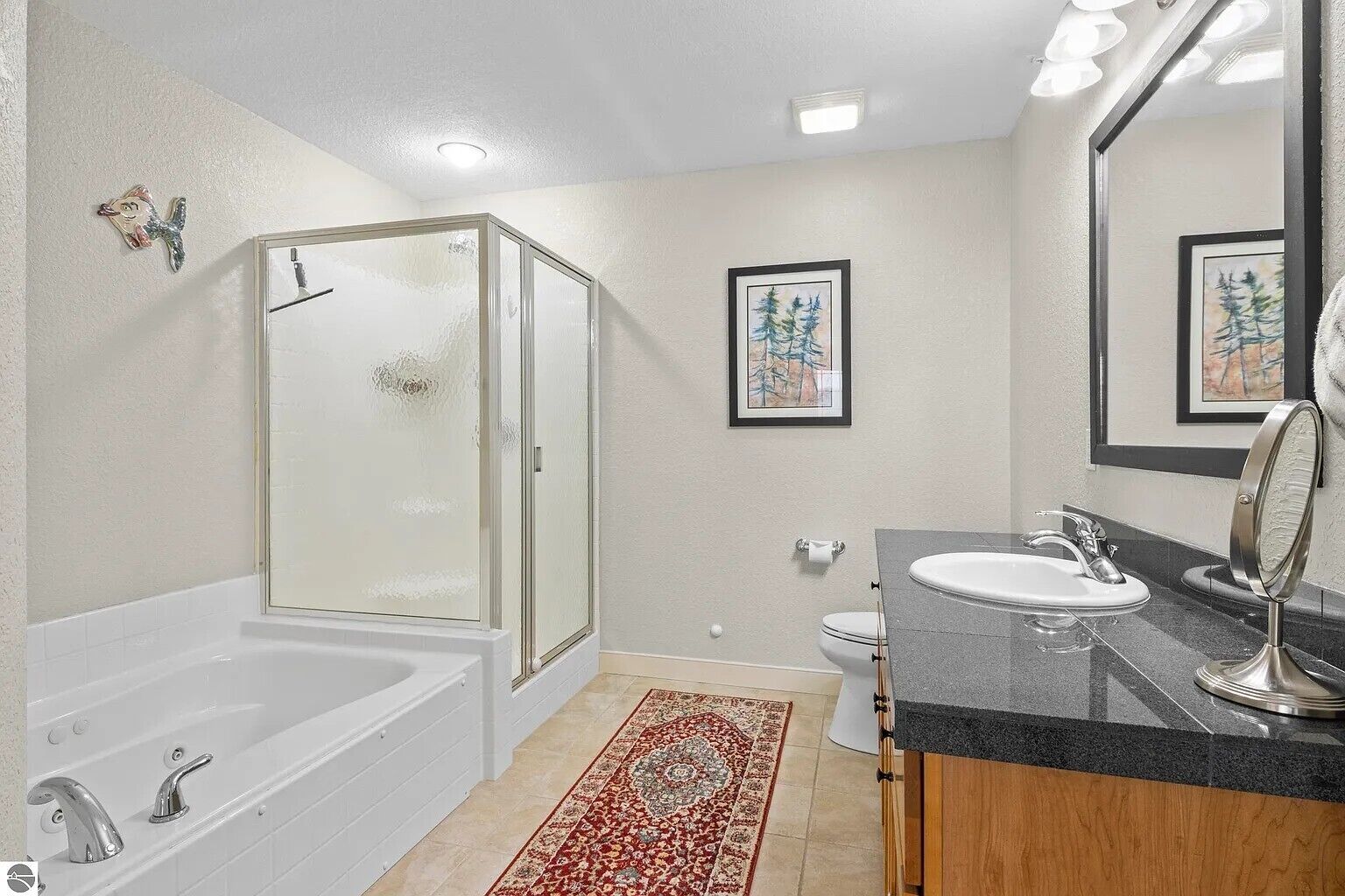 A bathroom with a bathtub, shower, sink, and toilet.