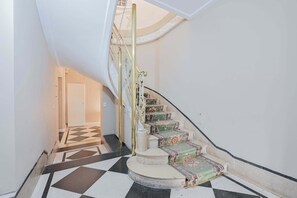 A staircase with ornate railings and patterned carpet. - LDV Aparts 6B by MOT Rentals (Buenos Aires)