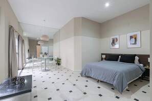 A modern bedroom with a bed, a desk, and a chair. - LDV Aparts 2F by MOT Rentals (Buenos Aires)