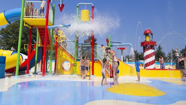 A water park with slides, a splash pad, and a lighthouse structure. - Zeeland Glamping Lodge for 2 (Burgh-Haamstede)