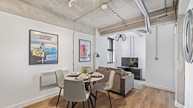 A modern living space with a dining area, sofa, and a TV. - Apartment 18 - The Works (Woolston)