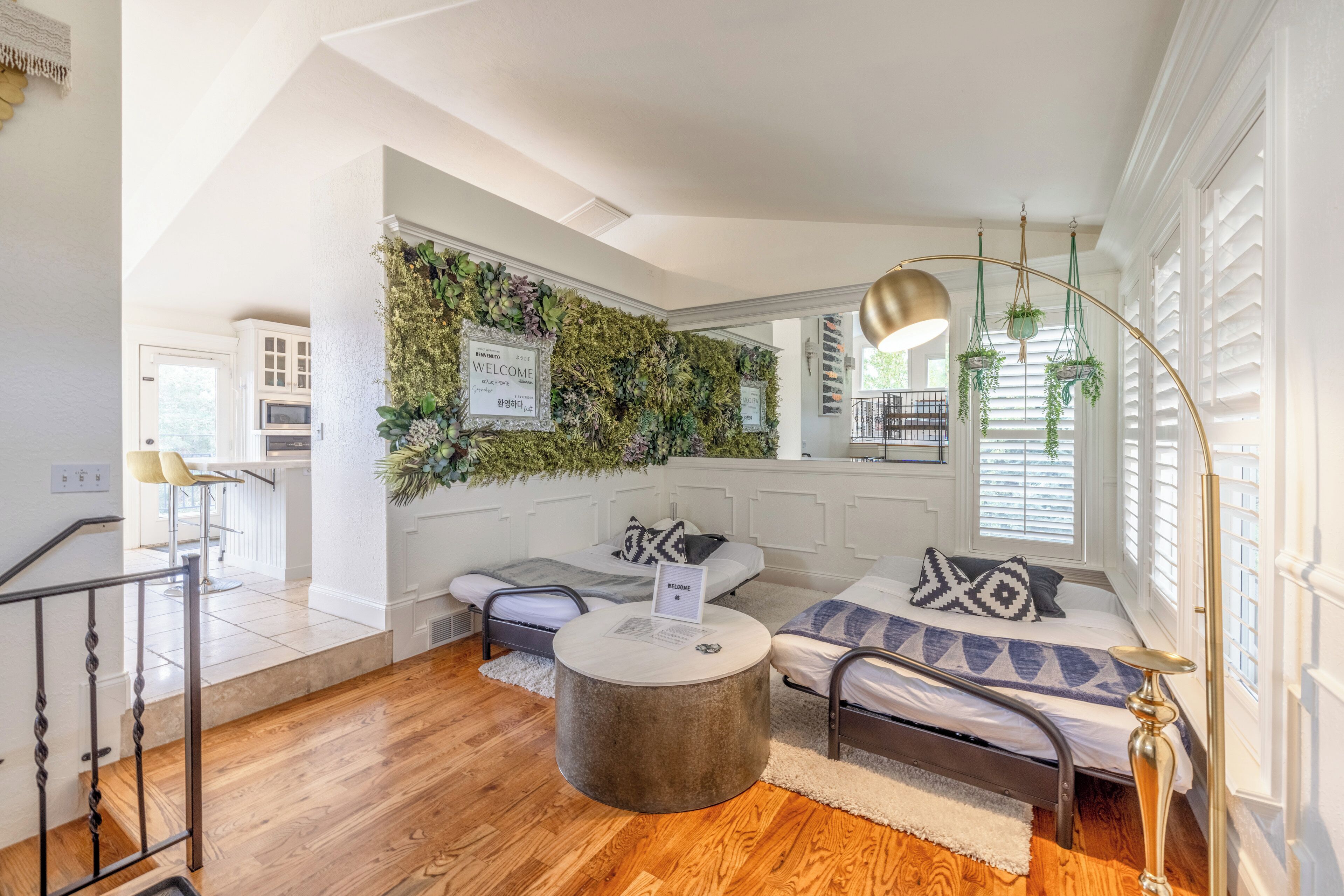 A modern living room with a sofa, a coffee table, and a wall-mounted plant.