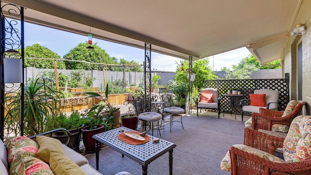 An outdoor patio with a table, chairs, and potted plants. - 55-plus Community w/ Pool! Snowbird Escape in Mesa (Mesa)