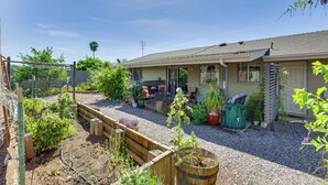 A residential property with a garden, outdoor seating, and a garage. - 55-plus Community w/ Pool! Snowbird Escape in Mesa (Mesa)