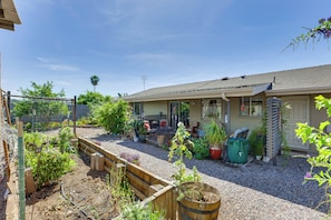 A residential property with a garden, outdoor seating, and a garage.