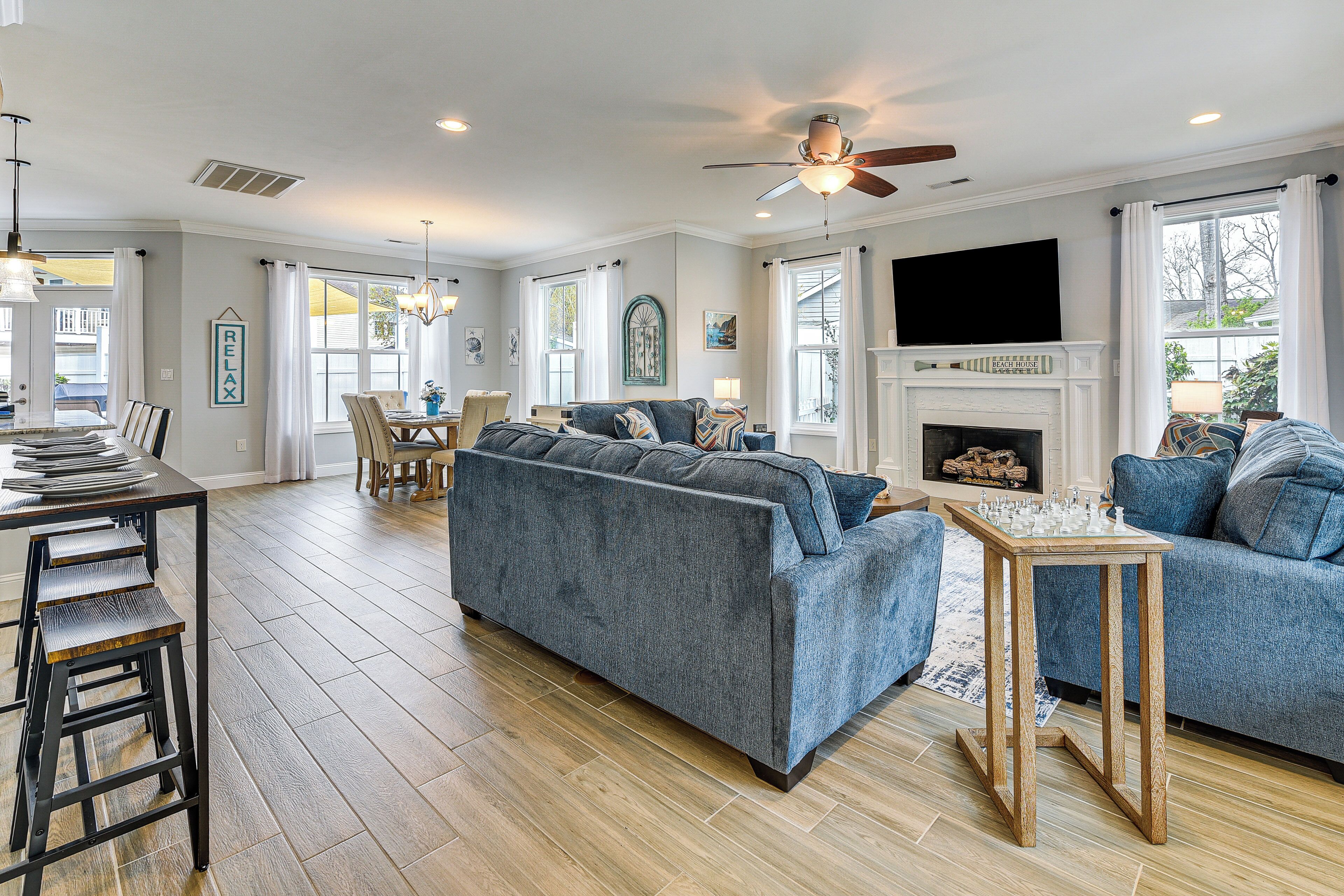 A spacious living room with a sofa, a coffee table, and a fireplace.