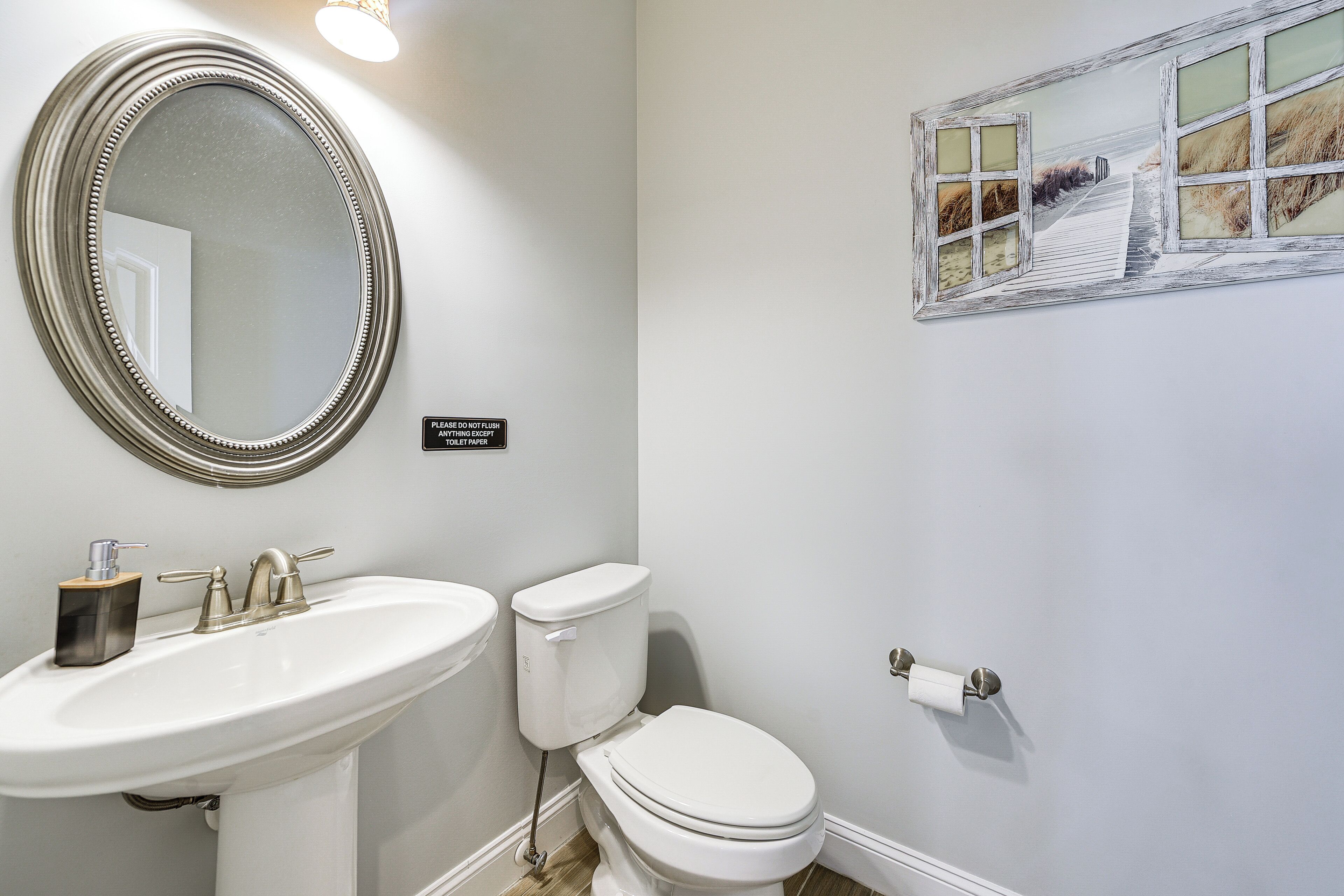 Ein Badezimmer mit Waschbecken, Toilette und Spiegel.