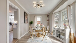 A dining area with a table, chairs, and a chandelier. - Free Parking! Townhome 3 Mi to Dtwn Rochester (Rochester)