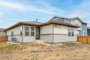 A two-story house with a front porch, a small front yard, and a wooden fence. - 5 Mi to Barr Lake State Park: Home w/ Game Room! (Brighton)