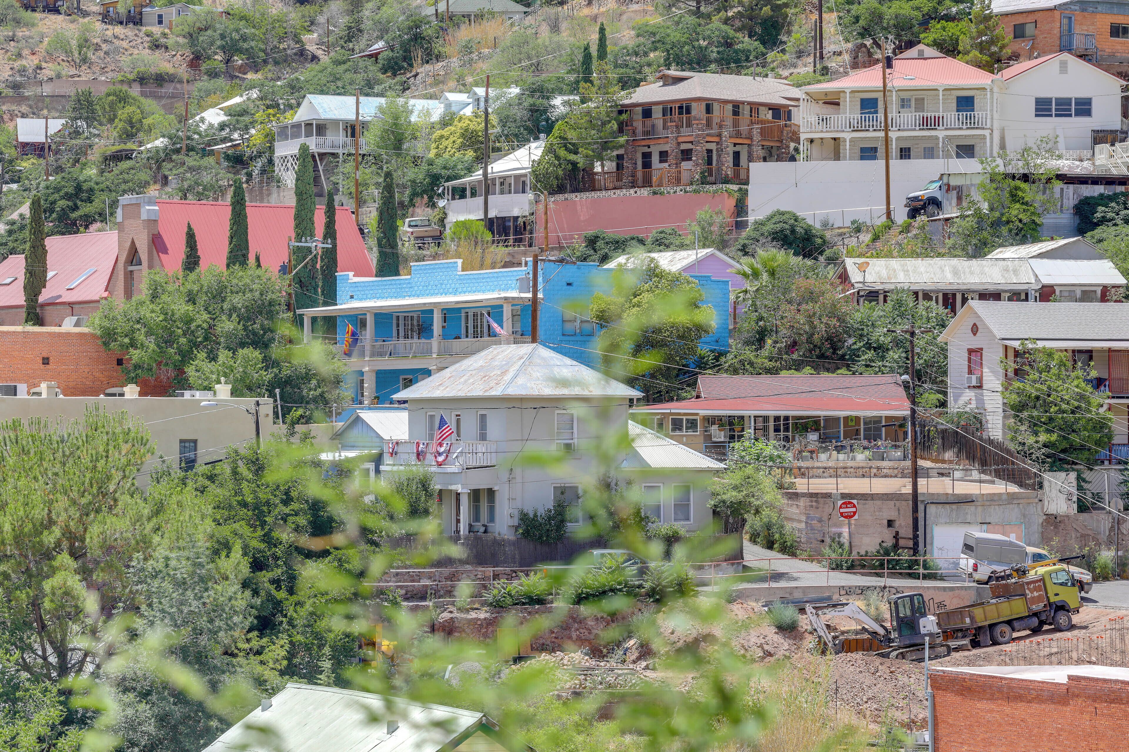 A residential area with houses, a visible American flag, and a construction site with a yellow truck.