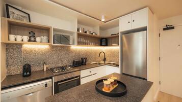A modern kitchen with a granite countertop, stainless steel appliances, and a built-in oven.
