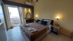 A bedroom with a bed, bedside tables, a mirror, a small table, and a view of the outside. - Tsiamis Sea Sun - Cozy and Stylish Nest (Corinth)