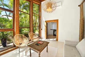 Deluxe Quadruple Room, Lanai, Garden View | Living area