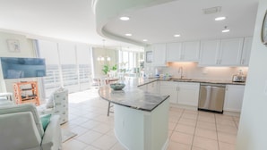 A modern kitchen with white cabinets, a marble countertop, and a stainless steel dishwasher. - 1815 North Hampton, Ocean View Condo With Full Access!! 3 Bedroom Condo (Myrtle Beach)