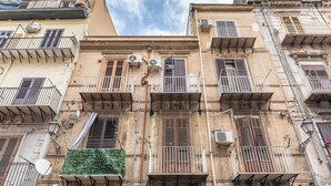 A multi-story building with balconies, air conditioning units, and a satellite dish. - The Gem of the Kalsa by Wonderful Italy (Palermo)