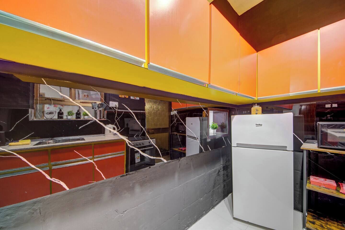 A kitchen with a refrigerator, stove, and various appliances.