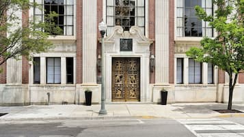 A building facade with a large ornate entrance, brick columns, and a sign reading 'The Miners National Bank.'