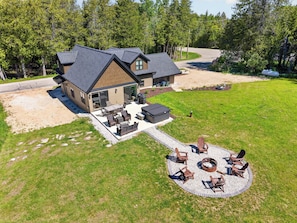 A house with a patio, outdoor seating, and a fire pit.
