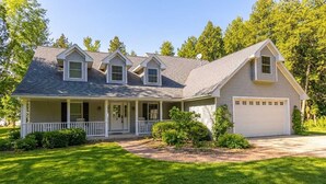 A single-story house with a front porch, a garage, and a well-maintained lawn.
