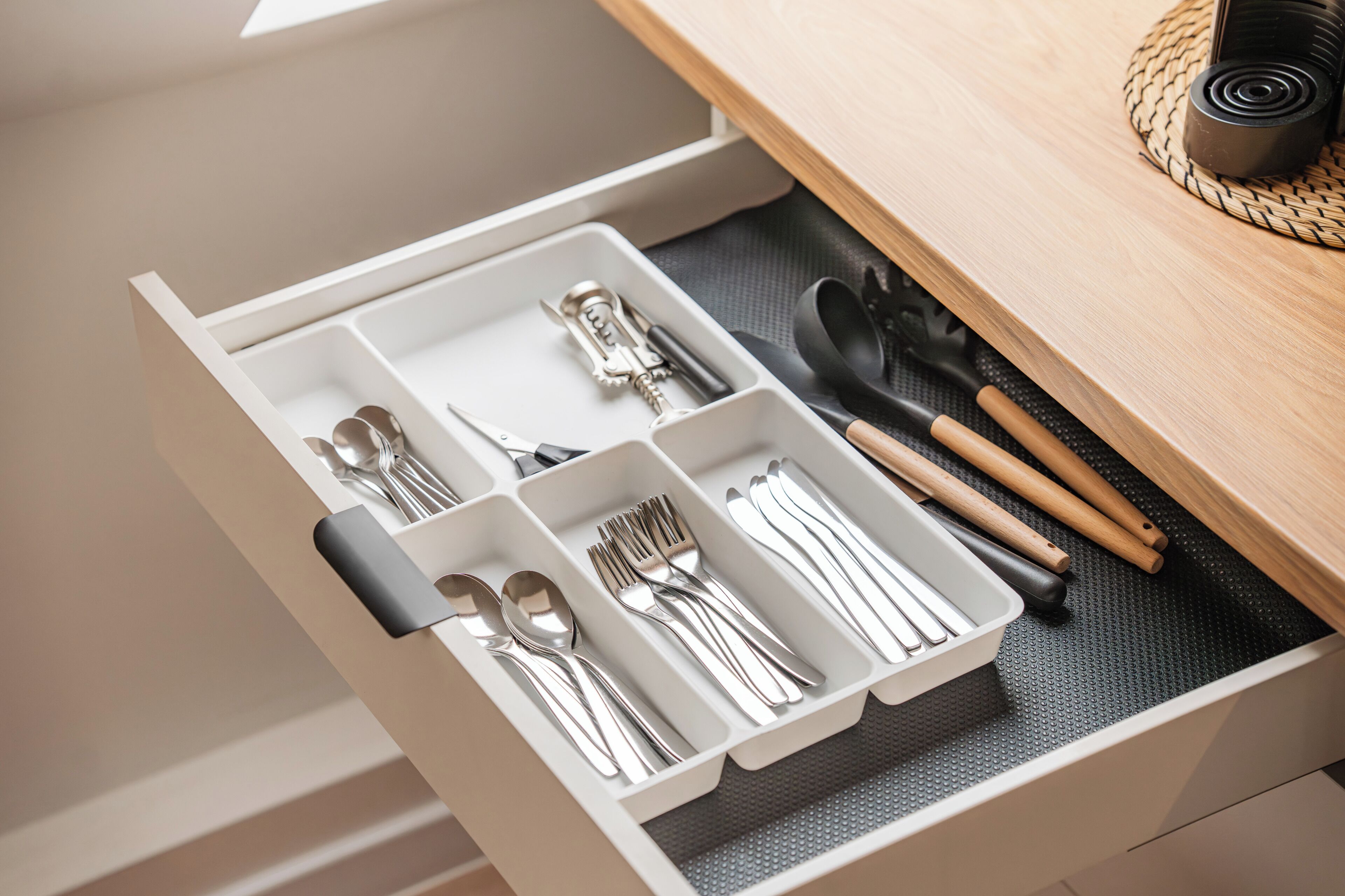 A drawer with utensils and cutlery.