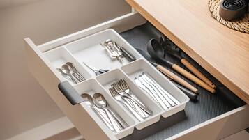 A drawer with utensils and cutlery.