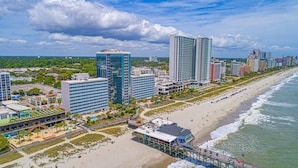 A coastal cityscape with high-rise buildings, a beach, and a pier. - Yachtsman S302 Studio (Myrtle Beach)