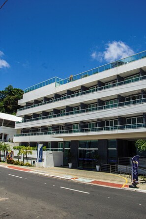 A multi-story building with a modern architectural design, featuring balconies and large windows. - Blue Sunset By Sun&Sea (João Pessoa)