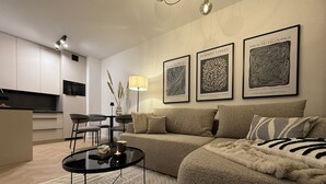 Un salon moderne avec un canapé, une table basse et des œuvres d’art murales.