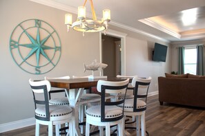 Dining area featuring a rustic high-top table and coastal-themed decor. - The Rusty Pelican -Boat-Jet ski parking available (Mexico Beach)