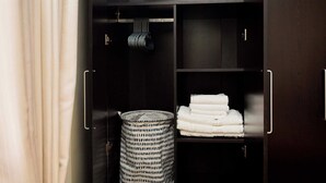A dark wooden wardrobe with multiple shelves and a basket. - Willows Court (Accra)