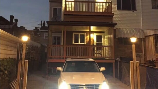 A two-story house with a balcony, a car parked in front, and a fence. - NFL Draft week 3 Bedroom Bloomfield 10 minutes to Acrisure 3 parking spaces (Pittsburgh)