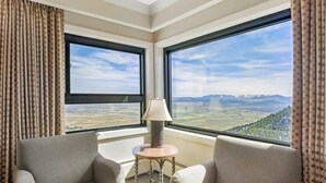 A room with two sofas, a lamp, and a view of a mountainous landscape through large windows. - Mountain Villa w/ Fireplace near Heavenly (Stateline)
