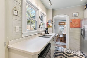 A kitchen with a white countertop, a dishwasher, and a refrigerator. - 5 Bedrooms, Walkable Location (St Simons Island)