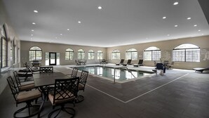 A spacious indoor swimming pool area with multiple seating arrangements and large windows. - King Suite w/ Pool & Breakfast | Near Downtown (Holland)