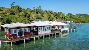 A waterfront property with multiple overwater bungalows connected by a wooden deck. - Coral Wing Casitas (Bastimentos)