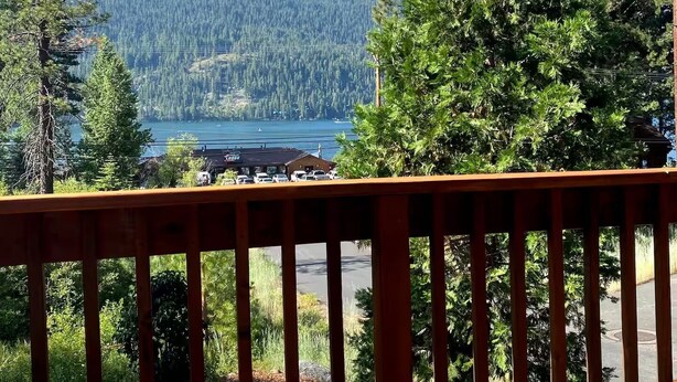 A wooden deck with a view of a lake and forest. - Gorgeous Donner Lake 3BR + Loft Modern Home in Truckee (Truckee)