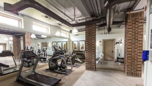 A gym with treadmills, elliptical machines, and weight equipment. - Dive into downtown, steps away! (Fort Worth)