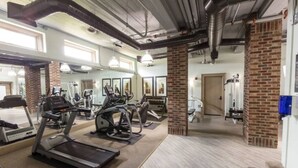 A gym with treadmills, elliptical machines, and weight equipment. - Relaxing Extended stays, walk Downtown! (Fort Worth)