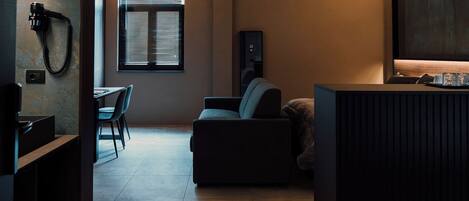 A compact living space with a sofa, a small table, and a TV.