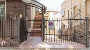 A gated entrance with a no parking sign, a metal gate, and a staircase leading to a building. - riMINI house - One Bedroom Apartment, Sleeps 2 (Rimini)