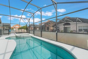 A swimming pool with a clear view of the sky and neighboring houses. - 5-Bed Villa w/ Private Pool (Davenport)