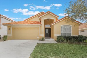 A residential house with a garage, a front entrance, and a well-maintained lawn. - 5-Bed Villa w/ Private Pool (Davenport)