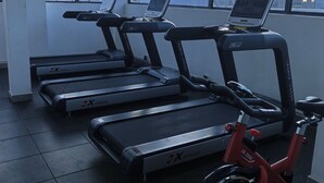 A gym with treadmills and a stationary bike, large windows with a city view, and a tiled floor. - Charming 1-bedroom apartment in vibrant Nairobi with fitness room (Nairobi)