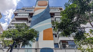 A multi-story building with balconies, a modern design, and a large abstract mural on the facade. - Update  (São Paulo)